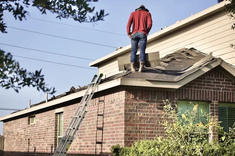 Professional roofer working on a residential roof in Harts Corner